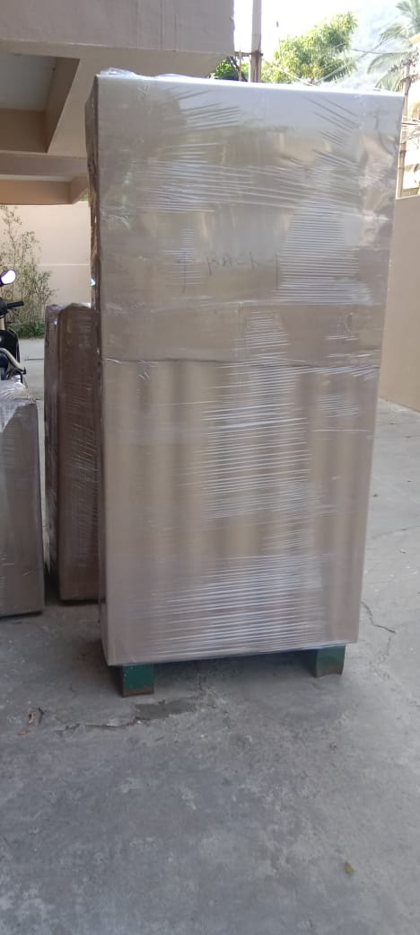Fully wrapped refrigerator on wooden pallet