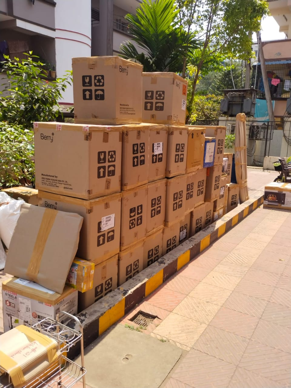 Neatly stacked moving boxes outside residence